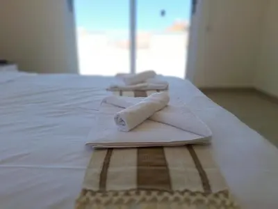 two towels sitting on top of a bed at Sunrise Palette Suites in Larnaka