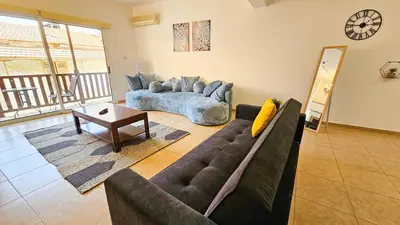 a living room with a couch and a table at SKY Way City Apartment, 150m from Chabad Lubavitch in Larnaka