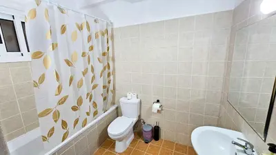 a bathroom with a toilet and a sink at SKY Way City Apartment, 150m from Chabad Lubavitch in Larnaka