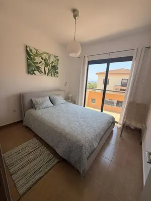 a bedroom with a bed and a large window at Dene Hollow kapparis in Paralimni
