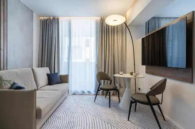 a living room with a couch and a table and chairs at 26 Suites in Limassol