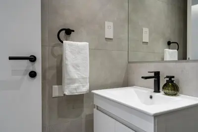 a bathroom with a sink and a mirror at 26 Suites in Limassol