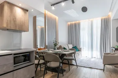 a kitchen and living room with a table and chairs at 26 Suites in Limassol