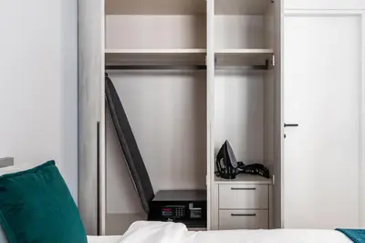 a bedroom with a bed and a closet with a staircase at 26 Suites in Limassol