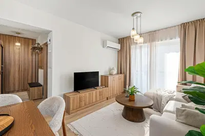 a living room with a couch and a tv at The Serene Suite in Larnaka