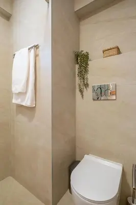 a bathroom with a toilet and a towel rack at The Serene Suite in Larnaka