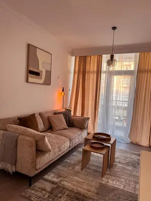 a living room with a brown couch and a table at Cozy & Stylish 1Bedroom Apartment in Limassol