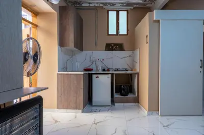 a kitchen with a white refrigerator in a room at Traditional Stone House in Vouni, Quiet Stay with Courtyard & BBQ in Vouni