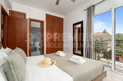 a bedroom with a bed and a large window at Villa Coral in Paralimni