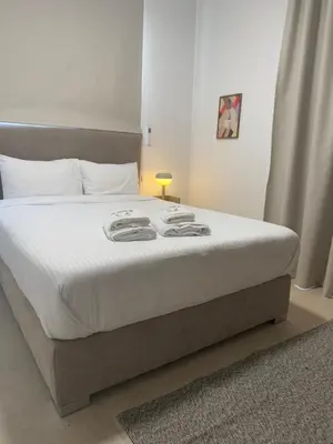 a bedroom with a large bed with white sheets at Kroisou Comfort Stay in Ayios Dhometios