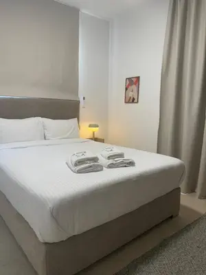 a bedroom with a large bed with white sheets at Kroisou Comfort Stay in Ayios Dhometios