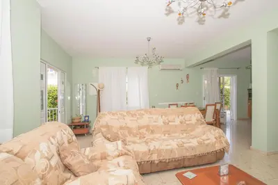 a living room with a couch and a couch and a table at Nissi Maria Villa in Ayia Napa