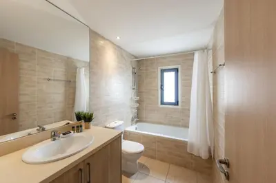 a bathroom with a sink and a toilet and a tub at Protaras Seaside Villa Protamare 32 in Protaras
