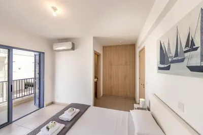 a bedroom with a bed and a large window at Protaras Seaside Villa Protamare 32 in Protaras