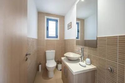 a bathroom with a toilet and a sink and a mirror at Protaras Seaside Villa Protamare 32 in Protaras