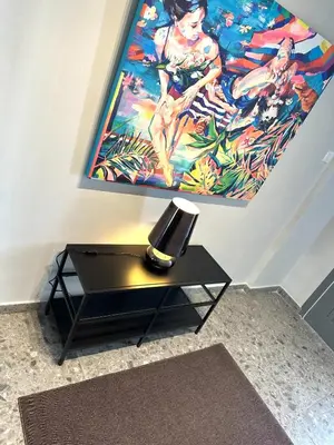 a black table with a lamp and a painting on the wall at Kallisti 1bd Central Stay - Wow View in Nicosia