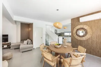 a dining room and living room with a table and chairs at SeaSalt Villa in Paralimni