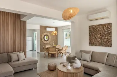 a living room with a couch and a table at SeaSalt Villa in Paralimni