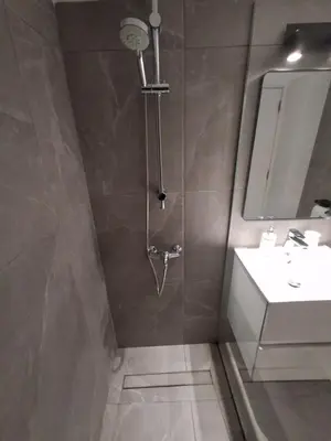 a bathroom with a shower and a sink at Lazuli Sea View & Pool Studio 303 in Larnaka