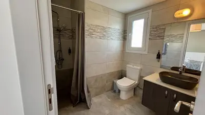 a bathroom with a sink and a toilet and a shower at Sunrise Villa with Pool by TrulyCyprus in Pervolia