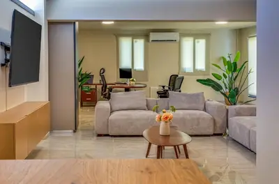 a living room with two couches and a table at Pantio Living Villa in Ayia Napa