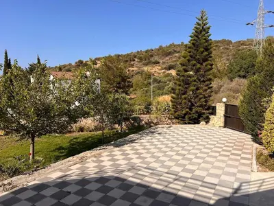 a stone walkway with trees and a mountain in the background at Villa Large Garden&Outdoor Space in Lageia