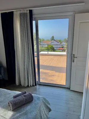 a bedroom with a large sliding glass door to a balcony at Villa Large Garden&Outdoor Space in Lageia