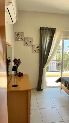a room with a desk and a window with a curtain at Villa Porta Aurea in Ayia Napa