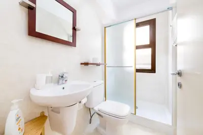 a bathroom with a toilet and a sink and a shower at Villa Enaria Serene 3Bdr Retreat in Ayia Thekla in Ayia Napa