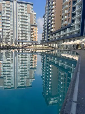 a reflection of buildings in a pool of water at Riverside Life Residence in İskele