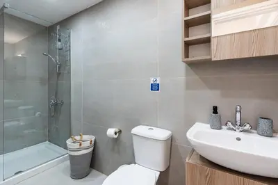 a bathroom with a toilet and a sink and a shower at Destiny 1-Bedroom Apartment in Larnaka