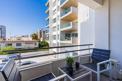 a balcony with two chairs and a table at Destiny 1-Bedroom Apartment in Larnaka