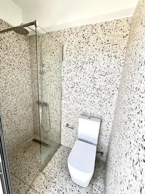 a bathroom with a toilet and a glass shower at STAY Mouson View Apartment in Limassol