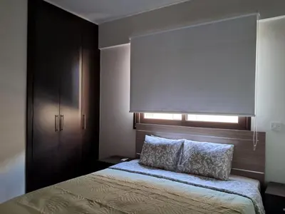 a bedroom with a bed with a window and a windowvisor at Lama's Residence in Nicosia