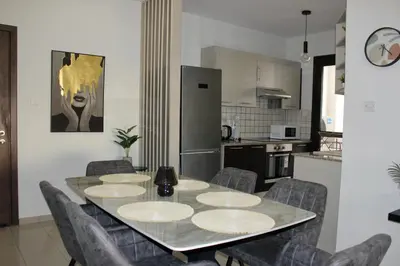 a kitchen and dining room with a table and chairs at Lama's Residence in Nicosia