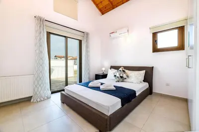 a bedroom with a bed and a large window at Kymma Seaview #24 in Ayia Napa