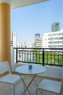 a balcony with a table and two chairs and a view at Stylish Modern City Center Stay in Nicosia