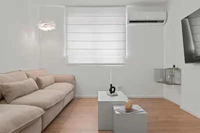 a living room with a couch and a table at Themelio Living 2-Bed Apartment Nicosia City Centre in Nicosia
