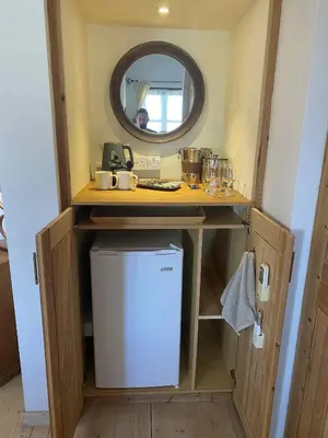 a small kitchen with a sink and a mirror at Olive Tree House in Anoyira