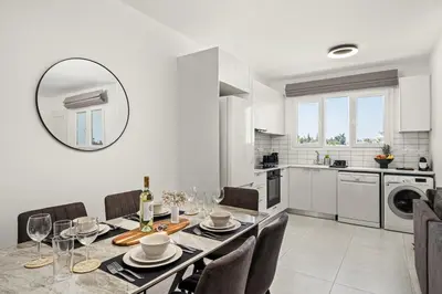 a kitchen and dining room with a table and chairs at Chic & Elegant Hideaway - Your Luxury Escape in Livadhia