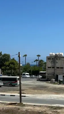 a parking lot with buses parked in a parking lot at Teak Charm in Larnaka