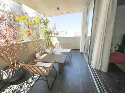 a balcony with a table and chairs and plants at Bridge House 301-3BR Penthouse in Limassol