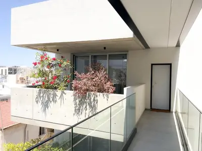 a building with a balcony with flowers on it at Bridge House 301-3BR Penthouse in Limassol