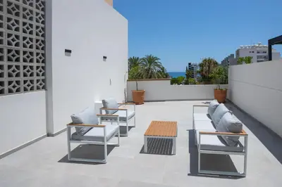 a patio with chairs and tables on a building at Bridge House 301-3BR Penthouse in Limassol