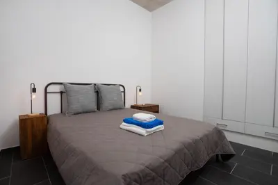 a bedroom with a bed with two towels on it at Bridge House 202-2BR Modern Apartment in Limassol