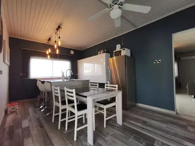 a kitchen with a table and chairs and a refrigerator at Larnaca Breeze in Pyla