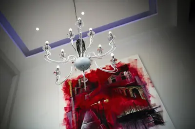 a chandelier hanging from a ceiling with a painting at The Josephine Boutique Hotel in Larnaka
