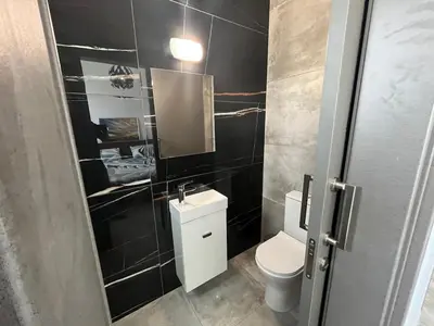 a bathroom with a toilet and a sink and a mirror at One Bedroom Penthouse Flat in Larnaka