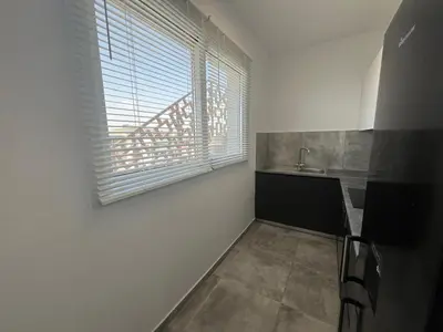a kitchen with a window and a sink and a counter at One Bedroom Penthouse Flat in Larnaka