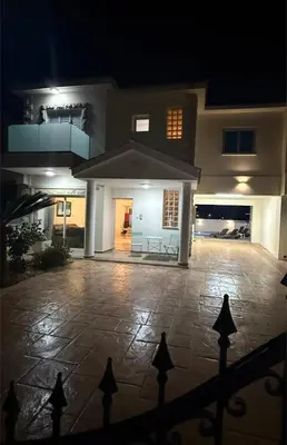 a house with a stone patio at night at Margarita Luxury 3 Bed & Pool in Dherinia